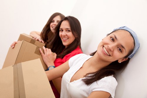Professional movers dismantling office furniture for relocation