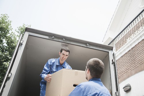 Removal team loading household items into a van
